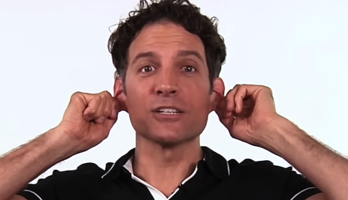 Gentle ear pulling exercise for TMJ-related ear fullness